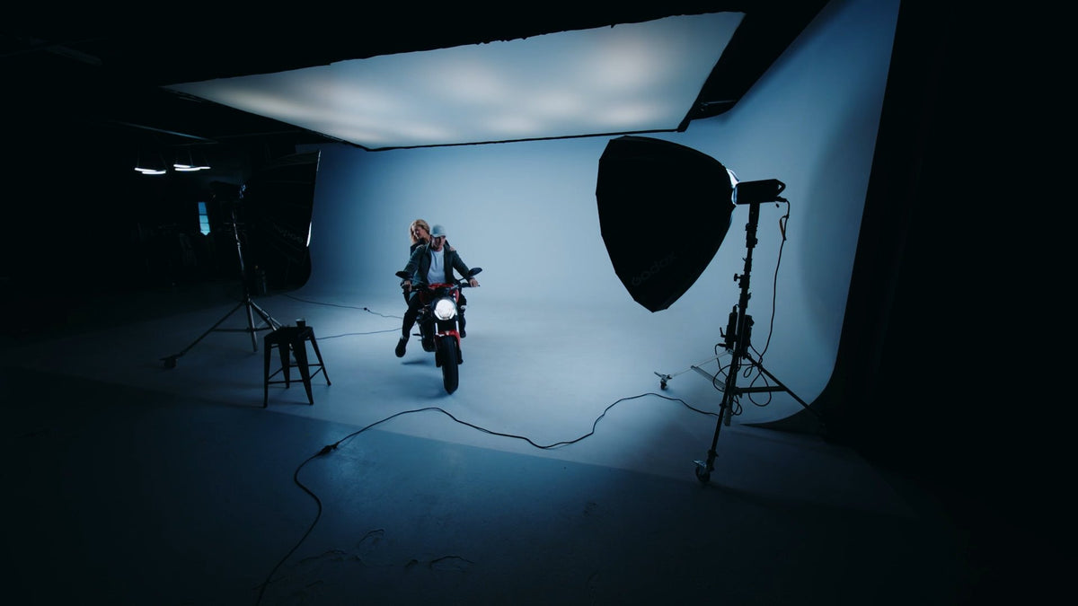 Two riders on a motorbike in a lit studio, from the Cib Label launch campaign film